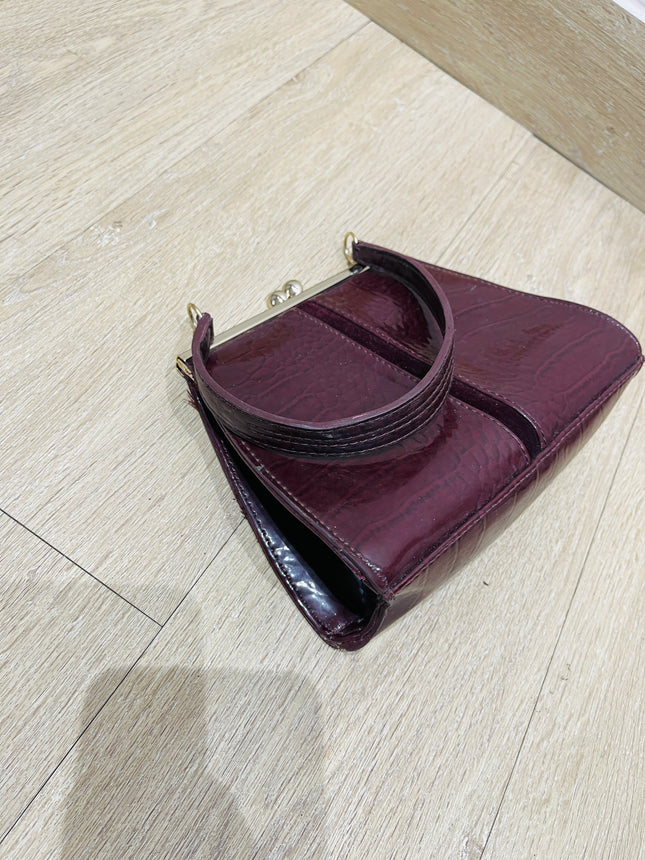 Women's maroon handbag with a crocodile skin